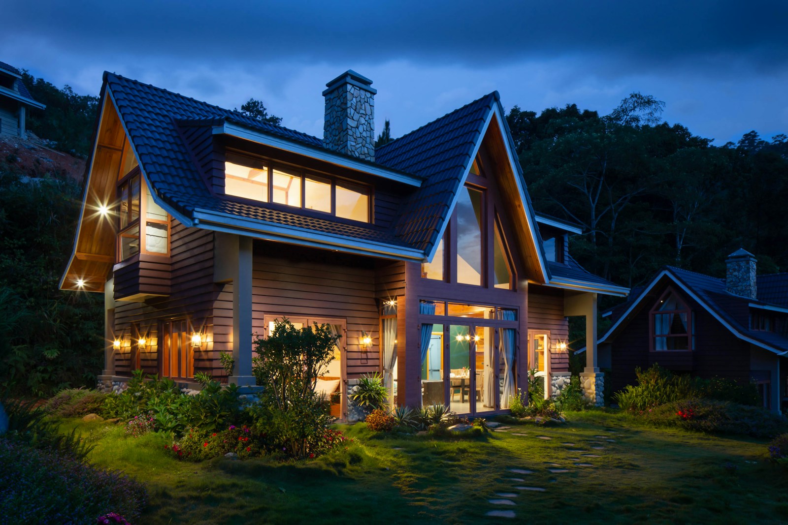 A home at dusk with a prominent pitched roof